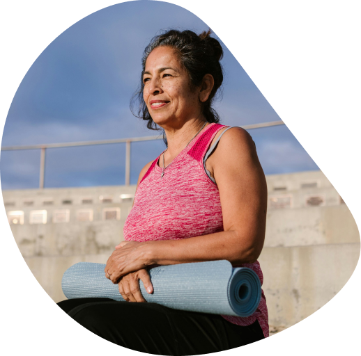 Woman doing yoga in a big room wearing yoga clothing